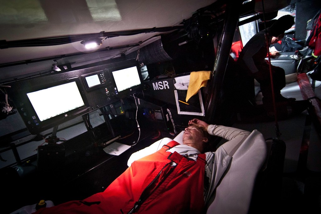 Skipper Ken Read takes advantage of some downtime for a quick nap at the Navigation Station while Jonathan Swain gets dressed for his on-watch in the background. PUMA Ocean Racing powered by BERG during leg 4 of the Volvo Ocean Race 2011-12, from Sanya, China to Auckland, New Zealand. (Credit: Amory Ross/PUMA Ocean Racing/Volvo Ocean Race) photo copyright Amory Ross/Puma Ocean Racing/Volvo Ocean Race http://www.puma.com/sailing taken at  and featuring the  class