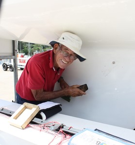 Face look familiar ? That's Olympic coach Mike Fletcher showing he is multi-skilled as helps prepare Mark Johnson's Roulette before they head out for a coaching session  - Zhik Etchells National Championship 2012 photo copyright Tracey Johnstone taken at  and featuring the  class