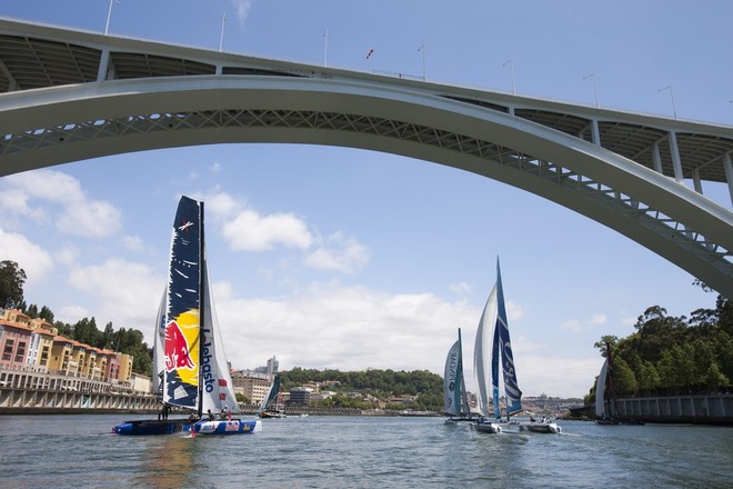 The fleet race under a bridge back towards the race village on day 2 in Porto - Extreme Sailing Series 2012 Act 4 © Roy Riley / Lloyd Images http://lloydimagesgallery.photoshelter.com/