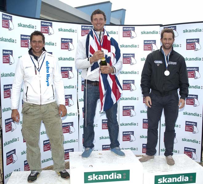 Giles Scott, Ben Ainslie (GBR), Pieter Jan Postma (NED), receives awards on Day 6 of the Skandia Sail for Gold Regatta, in Weymouth and Portland, the 2012 Olympic venue. © onEdition http://www.onEdition.com