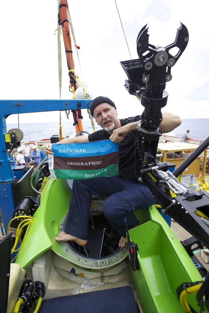 Filmmaker and National Geographic Explorer-in-Residence James Cameron holds the National Geographic Society flag after he successfully completed the first ever solo dive to the Mariana Trench. The dive was part of DEEPSEA CHALLENGE, a joint scientific expedition by Cameron, the National Geographic Society and Rolex to conduct deep-ocean research. - Deepsea Challange © Mark Thiessen National Geographic