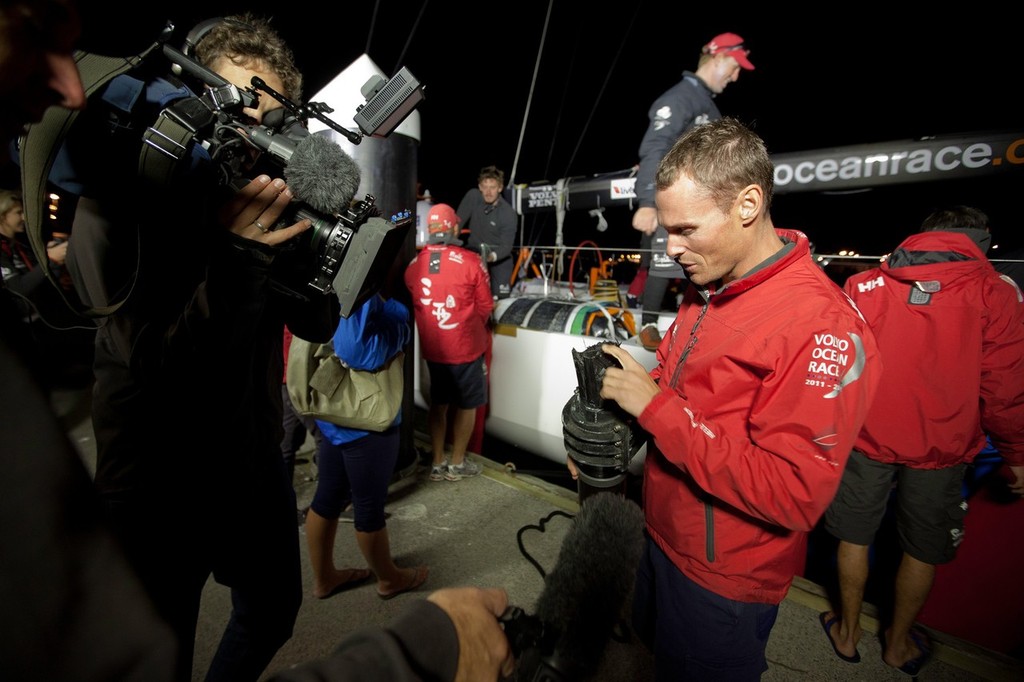 Shore Manager Nick Bice shows the broken rudder stock. Team Sanya skippered by Mike Sanderson from New Zealand, arrive in Tauranga, New Zealand, after a broken rudder and hull damage forced them to sail back, during leg 5 of the Volvo Ocean Race 2011-12, from Auckland, New Zealand to Itajai, Brazil. They are now forced to retire from leg five and miss leg six of the race and ship their race boat and equipment to Miami. (Credit: Gareth Cooke/Volvo Ocean Race) © Gareth Cooke/Volvo Ocean Race http://www.volvooceanrace.com