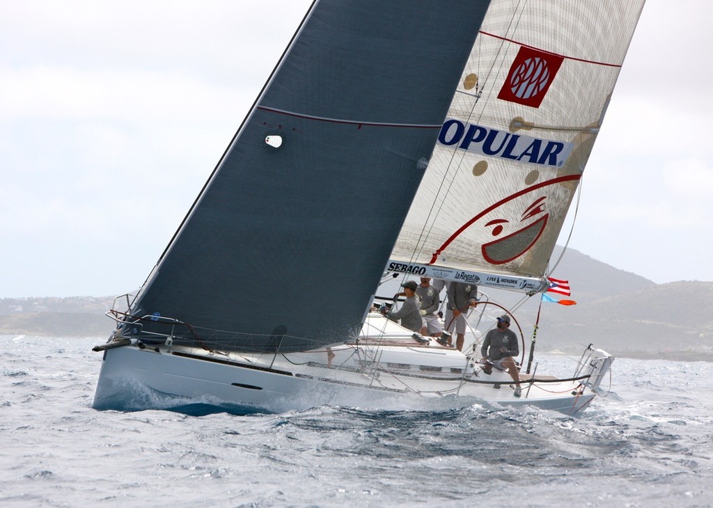 Smile and Wave Crushes through the Waves at the St. Maarten Heineken Regatta. photo copyright Tim Wright taken at  and featuring the  class