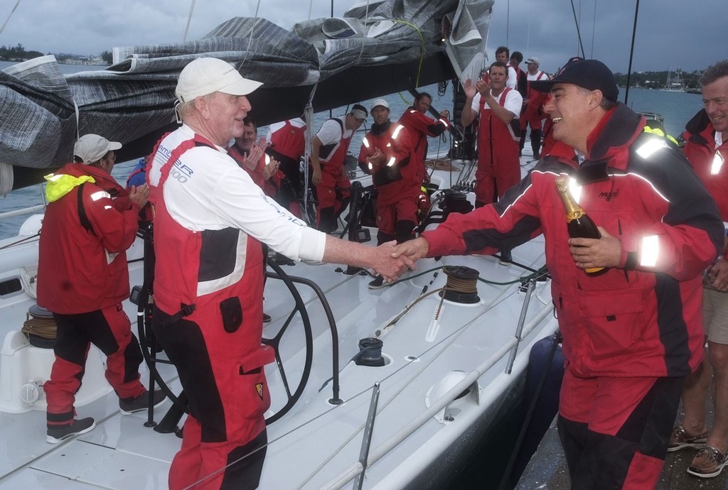 Commodore Jonathan Brewin welcomes George David to Bermuda with a bottle of champagne to celebrate Rambler’s record breaking finish - Newport Bermuda Race 2012 photo copyright PPL Photo Agency - copyright http://www.pplmedia.com taken at  and featuring the  class