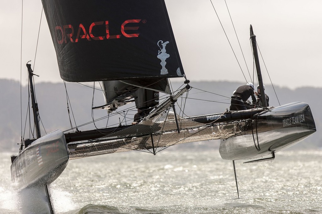 Oracle Team USA shows a hoisted L-dagger board, to windward, with the leeward hull fully supported and flying, while trialing in San Francisco on the AC45’s. The T-foil rudder is also evident, just clear of the water on the rear of the windward wull © Guilain Grenier Oracle Team USA http://www.oracleteamusamedia.com/
