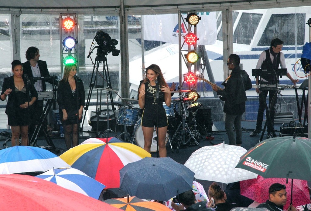 Fans crowd around the stage under a sea of umbrellas to watch Ricki-Lee perform © Rosalie Taylor
