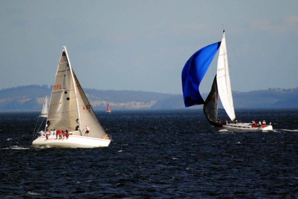 Invincible battles towards the windward mark as another boat struggles with its spinnaker in the strong NNW breeze on the Derwent today - Hobart Combined Clubs Harbour Race Series 2012 photo copyright Rob Cruse taken at  and featuring the  class