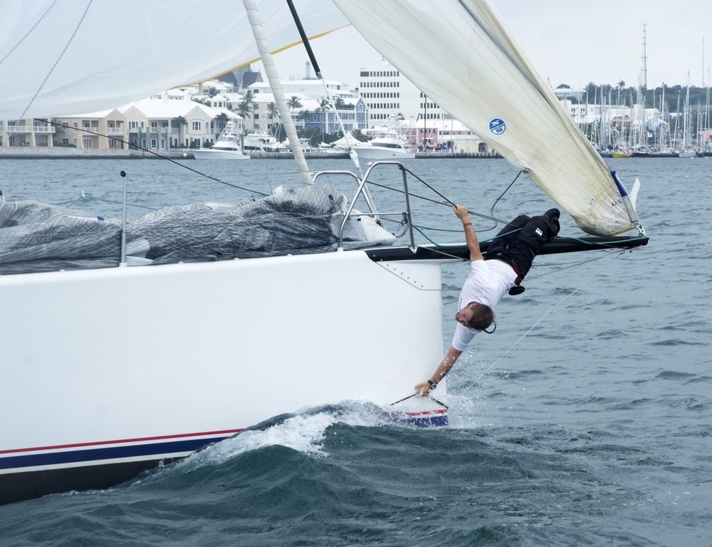 2012 RBYC Anniversary Regatta - Midshipman Sam Sipe, the bowman on Invictus, performs acrobatics close to the finish to retrieve the spinnaker sheet, shortly before the finish off the Royal Bermuda Yacht Club © Barry Pickthall/PPL http://www.pplmedia.com