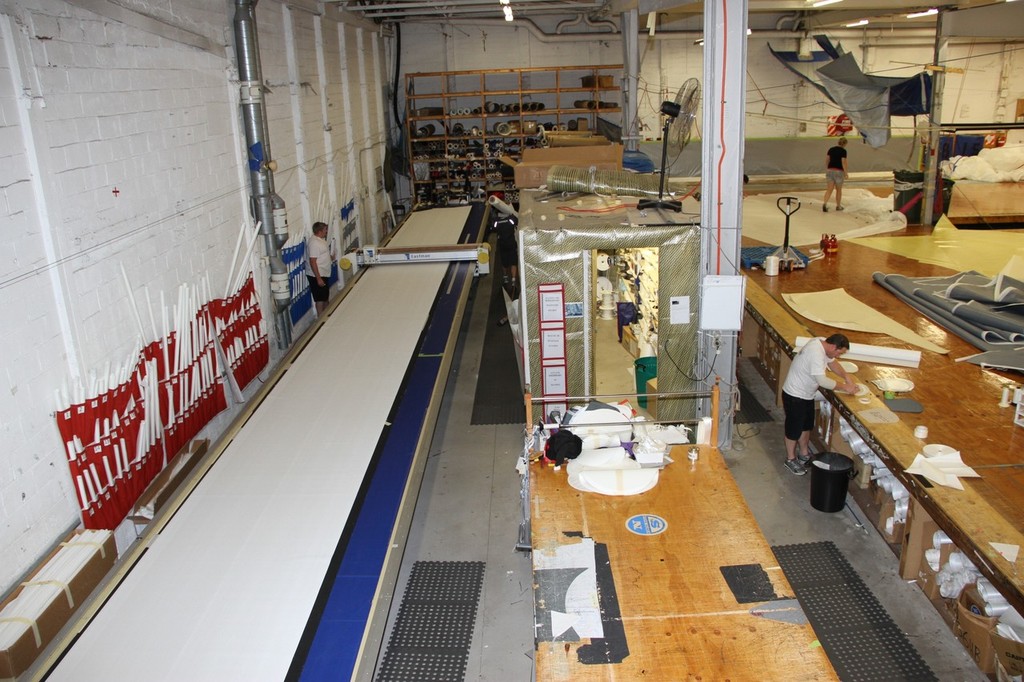 The 22metre long plotting table is not long enough for some panels in the J class spinnakers and the some have to be cut and joined. The numbered blue and red bags for panel storage/collection are on the wall behind the plotter. Note The sailcloth walled ``shed``.  North Sails. photo copyright Richard Gladwell www.photosport.co.nz taken at  and featuring the  class