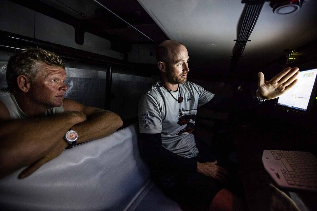Tom Addis talks strategy with watch captain and helmsman Tony Mutter before he goes on deck. Onboard PUMA Ocean Racing powered by BERG during leg 6 of the Volvo Ocean Race 2011-12 © Amory Ross http://www.amoryross.com