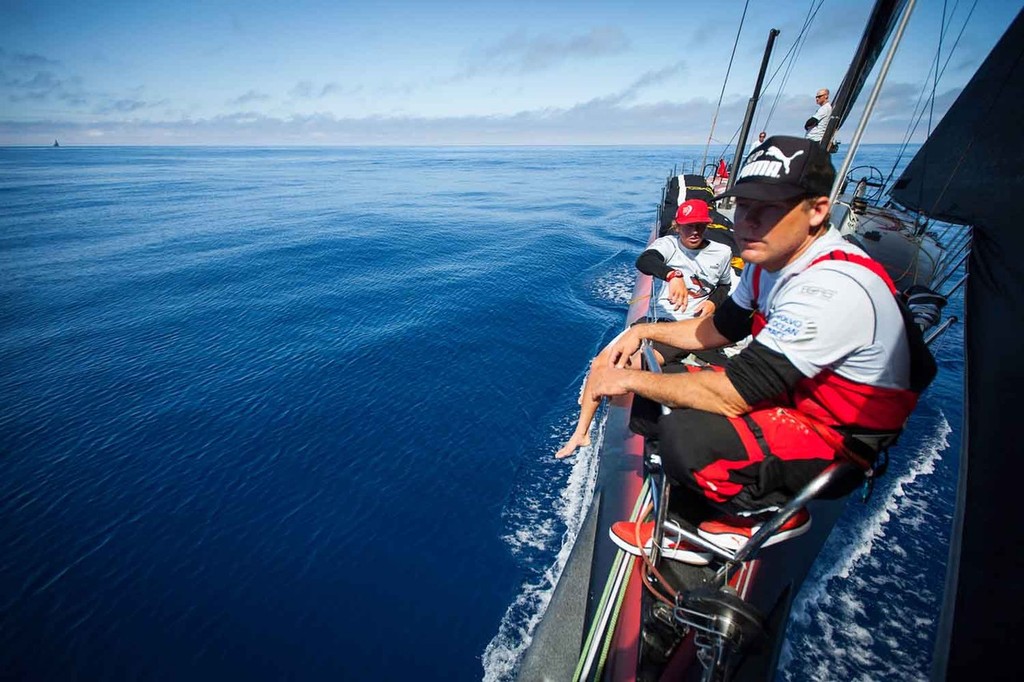 Casey Smith and Rome Kirby hang out on the bow while sailing through the ``Azores High`` andTelefonica drifts in the distance, onboard PUMA Ocean Racing powered by BERG during leg 8 of the Volvo Ocean Race 2011-12, from Lisbon, Portugal to Lorient, France. (Credit: Amory Ross/PUMA Ocean Racing/Volvo Ocean Race) photo copyright Amory Ross/Puma Ocean Racing/Volvo Ocean Race http://www.puma.com/sailing taken at  and featuring the  class