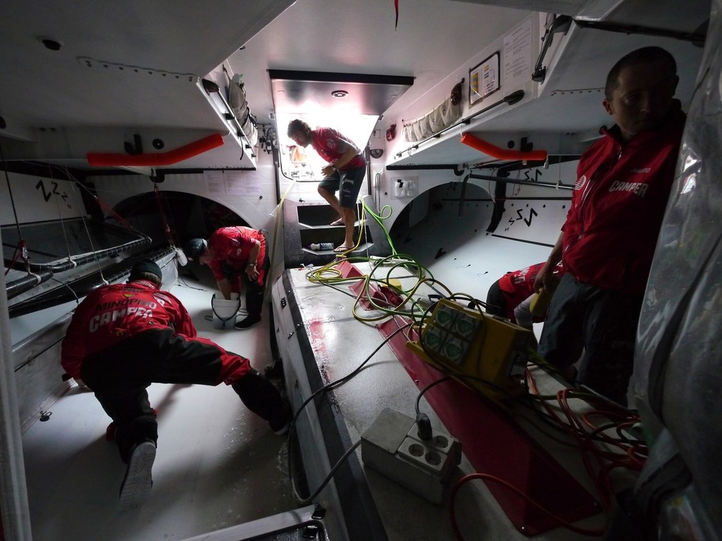 The sailing team washing the back half of the boat to remove all of the carbon dust. Camper in Puerto Montt, during Leg 5 of the Volvo Ocean Race 2011-12, from Auckland, New Zealand to Itajai, Brazil.  © Hamish Hooper/Camper ETNZ/Volvo Ocean Race