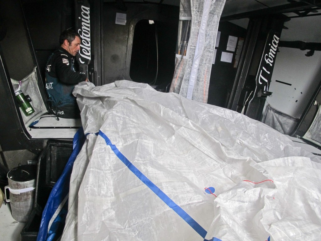 Jordi Calafat, fixing sails, onboard Team Telefonica during leg 8 of the Volvo Ocean Race 2011-12, from Lisbon, Portugal to Lorient, France.  © Diego Fructuoso /Team Telefónica/Volvo Ocean Race http://www.volvooceanrace.com