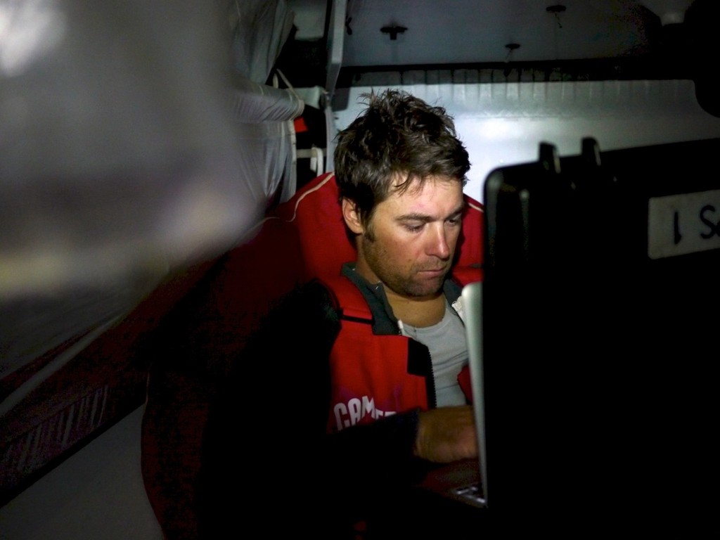 Daryl Wislang sending an email home from onboard CAMPER with Emirates Team New Zealand during leg 5 of the Volvo Ocean Race 2011-12, from Auckland, New Zealand to Itajai, Brazil. (Credit: Hamish Hooper/CAMPER ETNZ/Volvo Ocean Race) photo copyright Hamish Hooper/Camper ETNZ/Volvo Ocean Race taken at  and featuring the  class