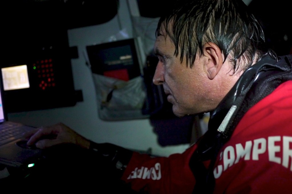 A drenched Will Oxley working in the navigation station, onboard CAMPER with Emirates Team New Zealand during leg 7 of the Volvo Ocean Race 2011-12, from Miami, USA to Lisbon, Portugal. (Credit: Hamish Hooper/CAMPER ETNZ/Volvo Ocean Race) photo copyright Hamish Hooper/Camper ETNZ/Volvo Ocean Race taken at  and featuring the  class
