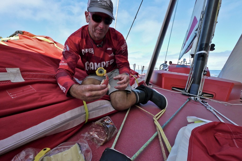 Rob Salthouse has a small picnic of cheese and jamon onboard CAMPER with Emirates Team New Zealand during leg 8 of the Volvo Ocean Race 2011-12, from Lisbon, Portugal to Lorient, France. (Credit: Hamish Hooper/CAMPER ETNZ/Volvo Ocean Race) photo copyright Hamish Hooper/Camper ETNZ/Volvo Ocean Race taken at  and featuring the  class