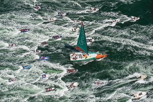 Groupama Sailing Team, skippered by Franck Cammas from France, are followed in by a huge fleet of spectator boats, after claiming victory in the Bretagne In-Port Race,in Lorient, France,during the Volvo Ocean Race 2011-12. © Paul Todd/Outside Images http://www.outsideimages.com
