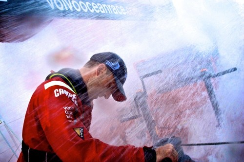 Andrew McLean bears the brunt of the force of the water on the aft grinding pedestal, onboard Camper during leg 7 of the Volvo Ocean Race 2011-12, from Miami, USA to Lisbon, Portugal.  © Hamish Hooper/Camper ETNZ/Volvo Ocean Race