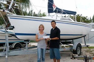 Jane Moon receives a sponsorship cheque on behalf of CISC from Jose Bush-Aleman at Harbour House Marina. photo copyright Byte Class http://bytechamps.org/ taken at  and featuring the  class