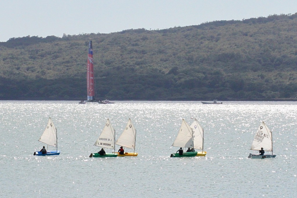 A Learn to Sail class at Wakatere BC crosses the AC72 as it sets up the other side of the Rangitoto Channel on Day 10  - Emirates Team NZ AC72 October 12,2012 photo copyright Richard Gladwell www.photosport.co.nz taken at  and featuring the  class