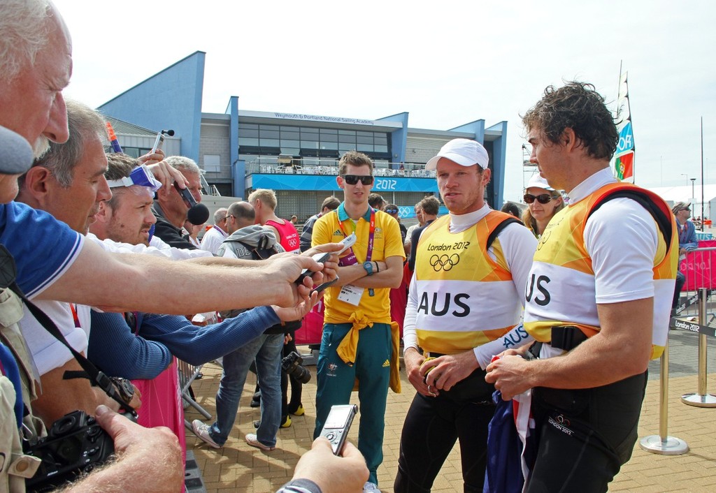 49er Gold medalists, Nathan Outteridge and Iain Jensen (right) milking the media zone, while their two minders (in sunglasses) from Yachting Australia positively purr in the background. © Richard Gladwell www.photosport.co.nz