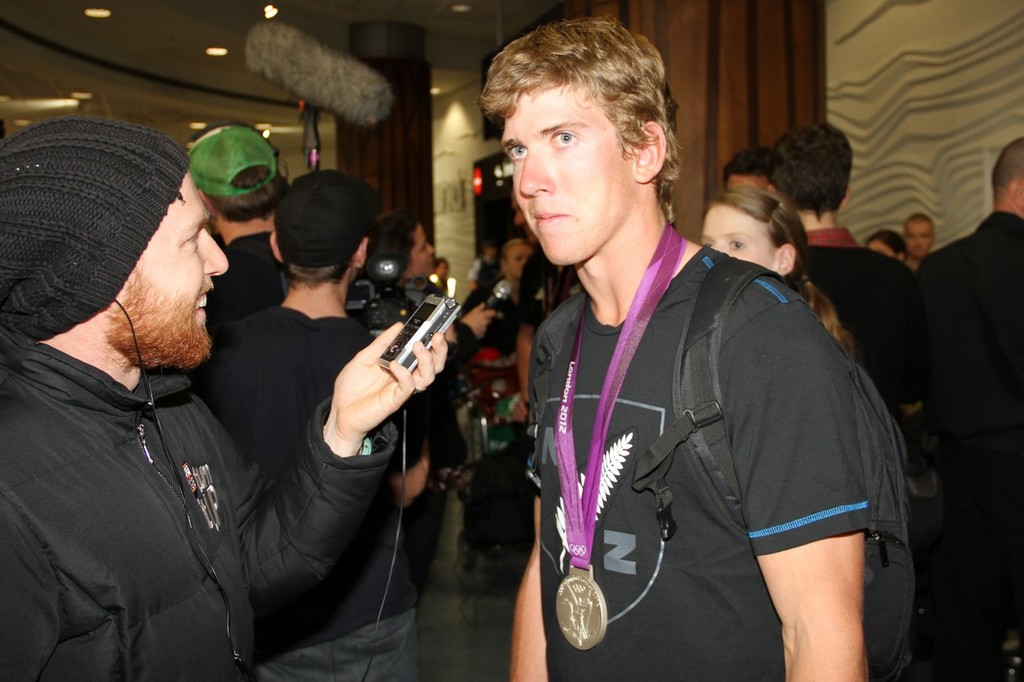  August 15, 2012 - Auckland, New Zealand- 49er Silver medalist, Peter Burling being interviewed on the Olympic Team's return to New Zealand photo copyright Richard Gladwell www.photosport.co.nz taken at  and featuring the  class