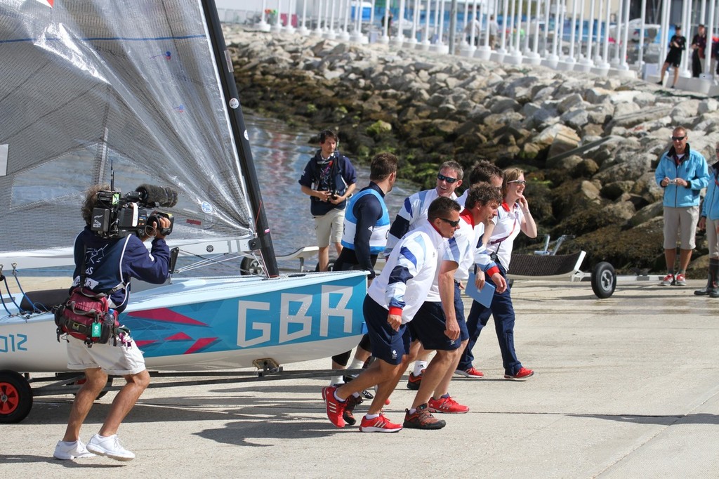  August 5, 2012 - Weymouth, England - Ainslie returns to dock to be greeted by members of the British team photo copyright Richard Gladwell www.photosport.co.nz taken at  and featuring the  class