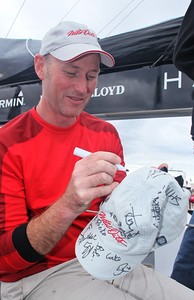 Tom Addis signs the Wild Oats XI crew hat - Rolex Sydney Hobart 2012 photo copyright Crosbie Lorimer http://www.crosbielorimer.com taken at  and featuring the  class