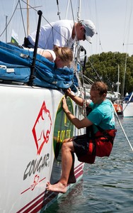 The all important sponsors decals go on the bow of Cougar II. - Rolex Sydney Hobart Yacht Race photo copyright  Alex McKinnon Photography http://www.alexmckinnonphotography.com taken at  and featuring the  class