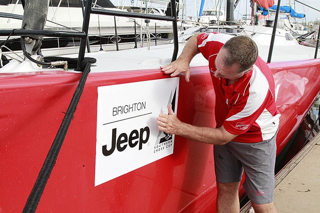 TP52 Southern Cross Cup, Sandringham Yacht Club, Melbourne (AUS) - Rob Date placing the Brighton Jeep bow stickers onto Scarlet Runner. © Teri Dodds - copyright http://www.teridodds.com