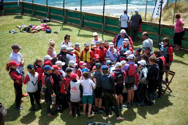 Sandy Bay Sailing Club Vice Commodore Ric Buchanan surrounded by Green fleet sailing for a weaher briefing on the clubhouse lawns - 2013 International Australian Optimist Championship © Dane Lojek