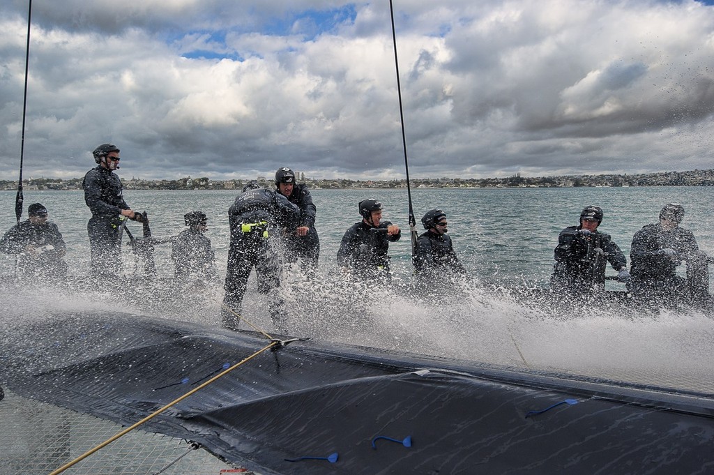 Emirates Team New Zealand. Day 13 of testing for the team’s first AC72. Hauraki Gulf, Auckland. The crew work hard under physically difficult conditions on a platform moving sometimes in excess of 40kts © Chris Cameron/ETNZ http://www.chriscameron.co.nz