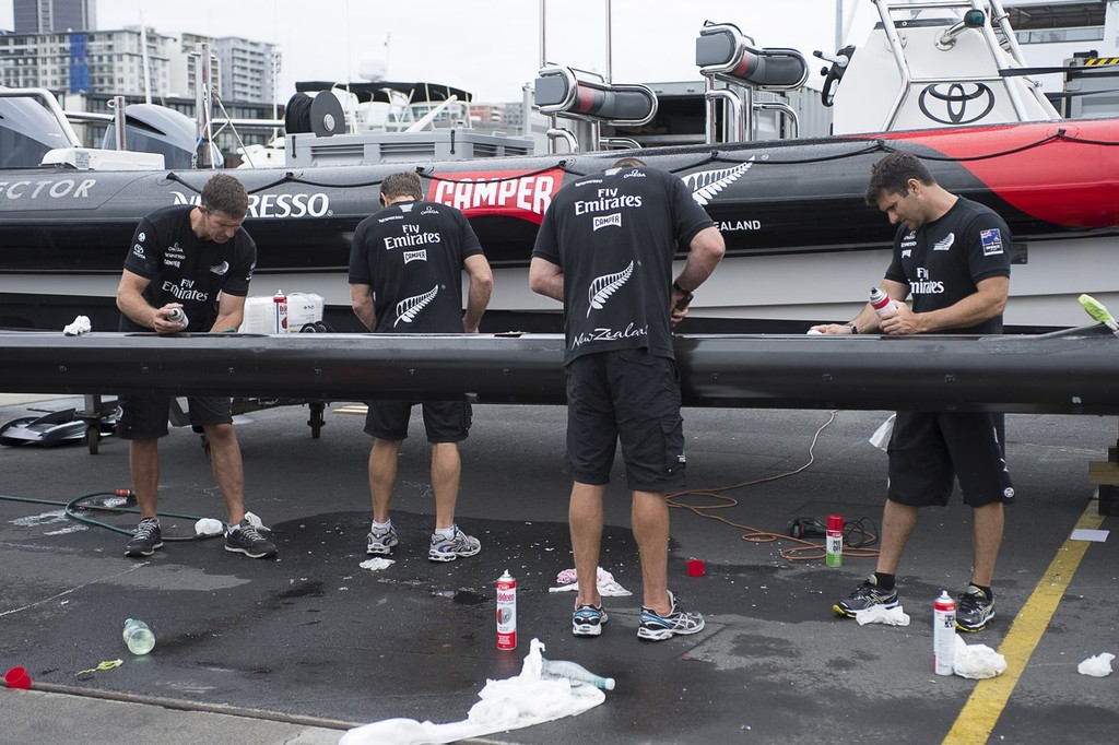 Emirates Team New Zealand sailors Derek Seward, Tony Rae, Rob Waddell and Jeremy Lomas clean up a beam from AC72 number 1 to be fitted to the teams second AC72. 15/1/2013 photo copyright Chris Cameron/ETNZ http://www.chriscameron.co.nz taken at  and featuring the  class
