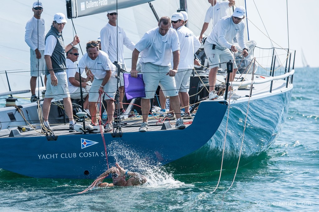 David Vera of Azzurra gets helped by his team mates after fixing a problem with the boat during day one at the Quantum Key West Race Week on January 21st 2013 in Key West, Florida, USA.  © Xaume Olleros / 52 Super Series