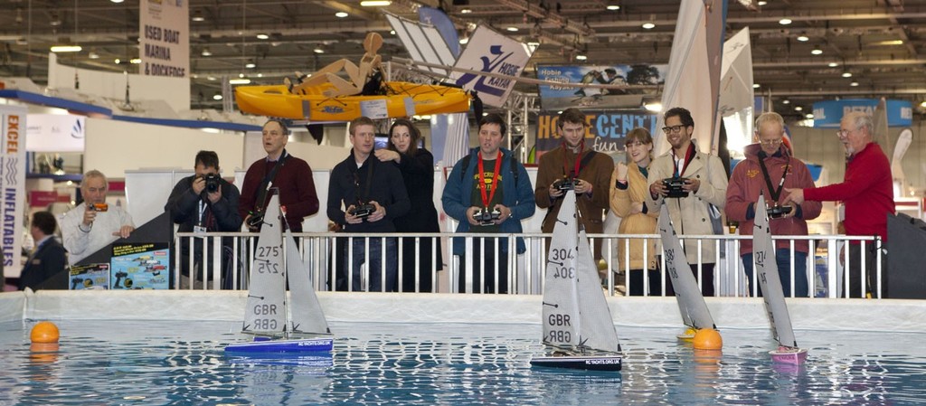 Visitors enjoying the ’On the Water Activity Pool’ model boat racing, at the Tullett Prebon London Boat Show, ExCeL, London.<br />
<br />
<br />
 © onEdition http://www.onEdition.com