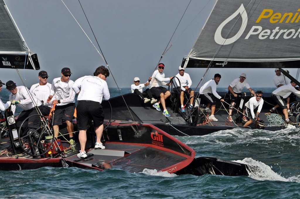 2013 RC44 Oman Cup - Ironbound&rsquo;s scoop is ripped away from the hull after a collision with Team Aqua photo copyright RC44 Class/MartinezStudio.es taken at  and featuring the  class