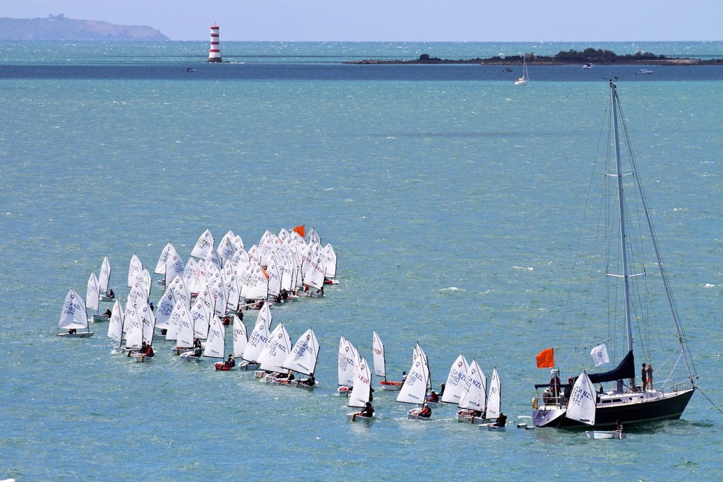 23 seconds before the start the first boats cross the leeward end of the starting line - 2013 Auckland Optimist Championships, Wakatere Boating Club © Richard Gladwell www.photosport.co.nz