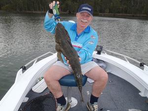 The author with a 79 cm dusky flathead that was caught while working soft plastics on a rising tide. photo copyright Gary Brown taken at  and featuring the  class