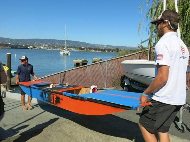 Carrying the finished boat to the water. Solomon Krevan and Ian Andrewes, American Youth Sailing Force © Kim Paternoster