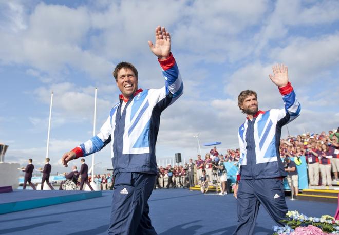 Iain Percy (right) and Andrew Simpson (GBR), acknowledge the crowd at the medal ceremony for the Men’s Keelboat (Star) event in The London 2012 Olympic Sailing Competition. © onEdition http://www.onEdition.com