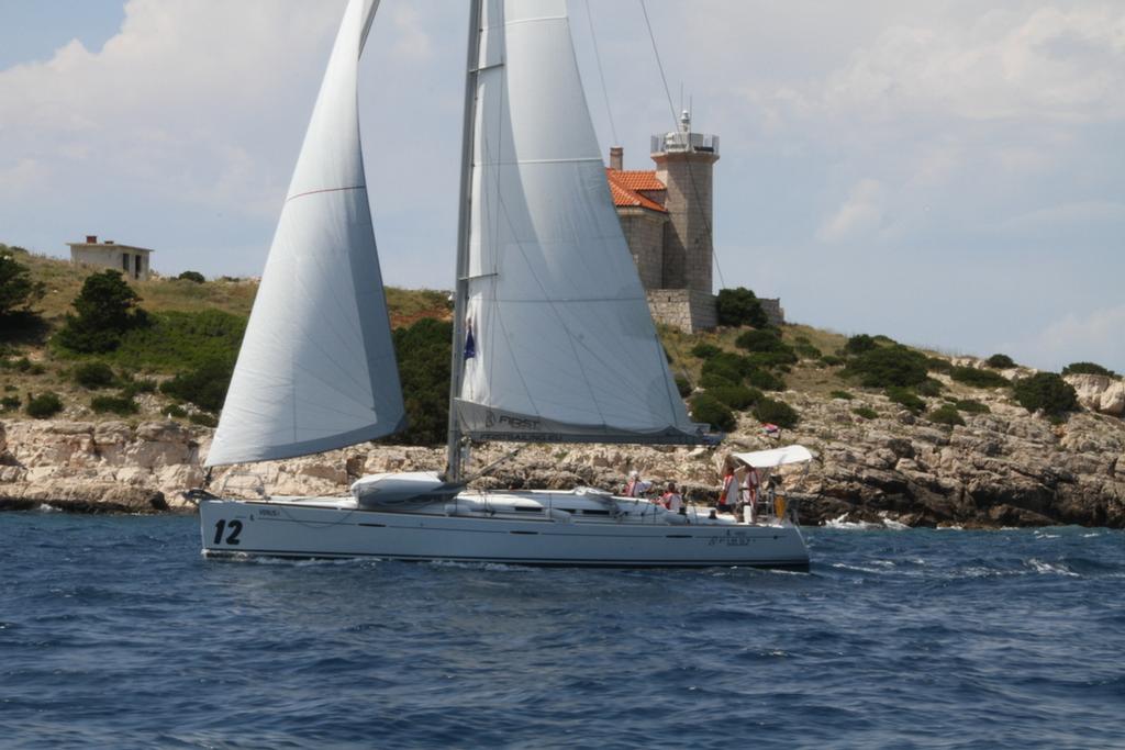 Finishing on the Vis lighthouse - Croatia One Design Yacht Rally photo copyright Maggie Joyce taken at  and featuring the  class