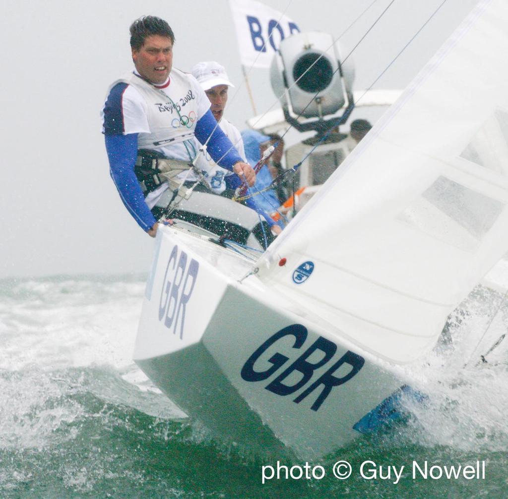 Andrew 'Bart' Simpson (crew) and Iain Percy, pursued by an Outside Broadcast boat having just won the gold medal in the Star class, Qingdao Olympic Regatta 2008. photo copyright Guy Nowell http://www.guynowell.com taken at  and featuring the  class