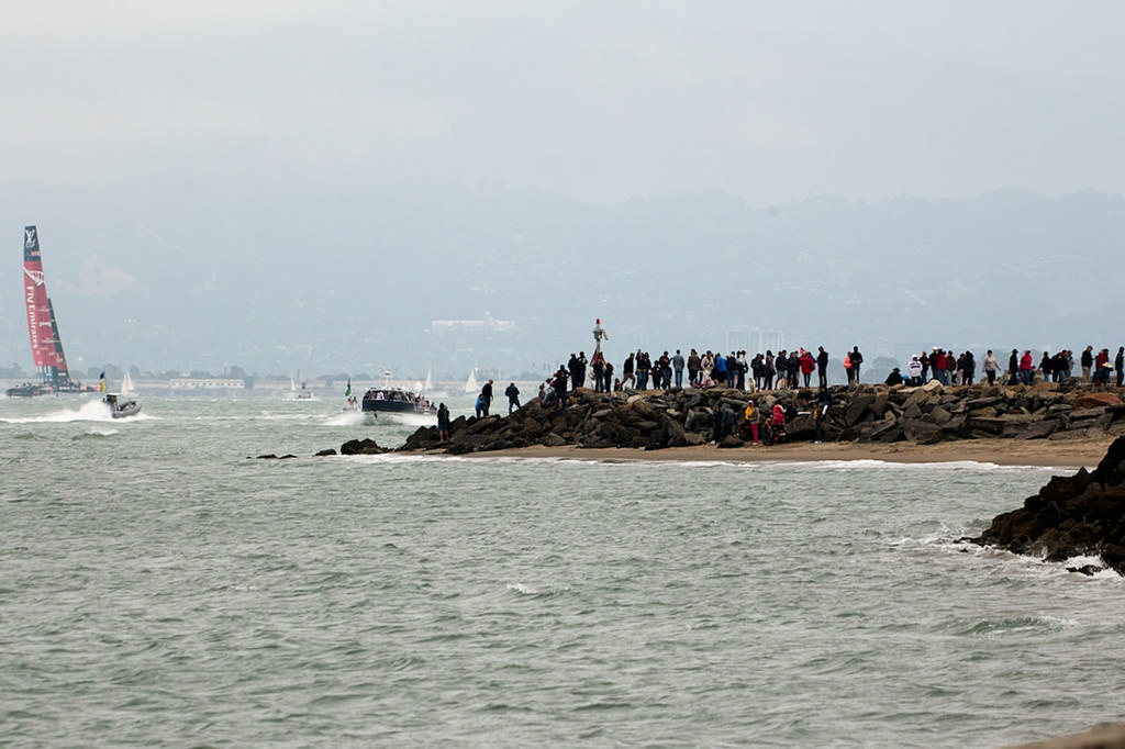 Spectators line the shore near America's Cup defender, the Golden Gate yacht club, as ETNZ finishes her solo run. - America's Cup 2013 photo copyright Chuck Lantz http://www.ChuckLantz.com taken at  and featuring the  class