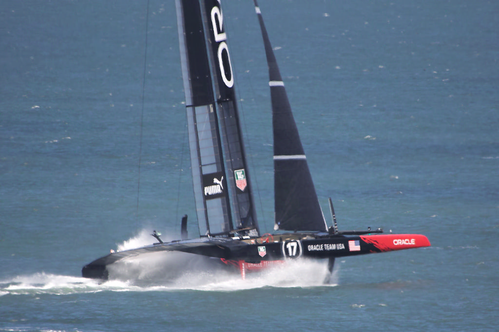 Oracle begins tossing up a roostertail as the boat powers-up.  - America's Cup © Chuck Lantz http://www.ChuckLantz.com