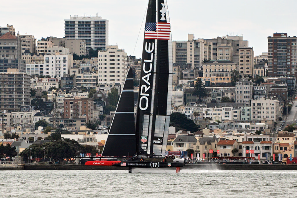 Oracle flies on their foils downwind past the San Francisco shore. - America's Cup © Chuck Lantz http://www.ChuckLantz.com