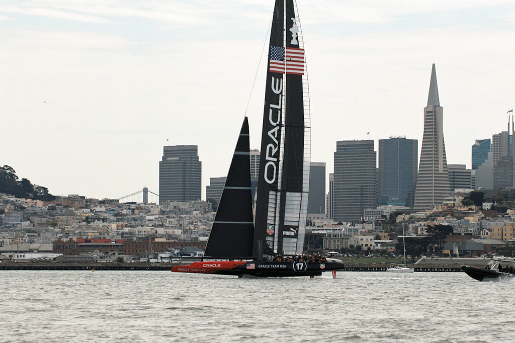 Oracle low on their foils, sails past the Trans America Pyramid building. - America's Cup © Chuck Lantz http://www.ChuckLantz.com