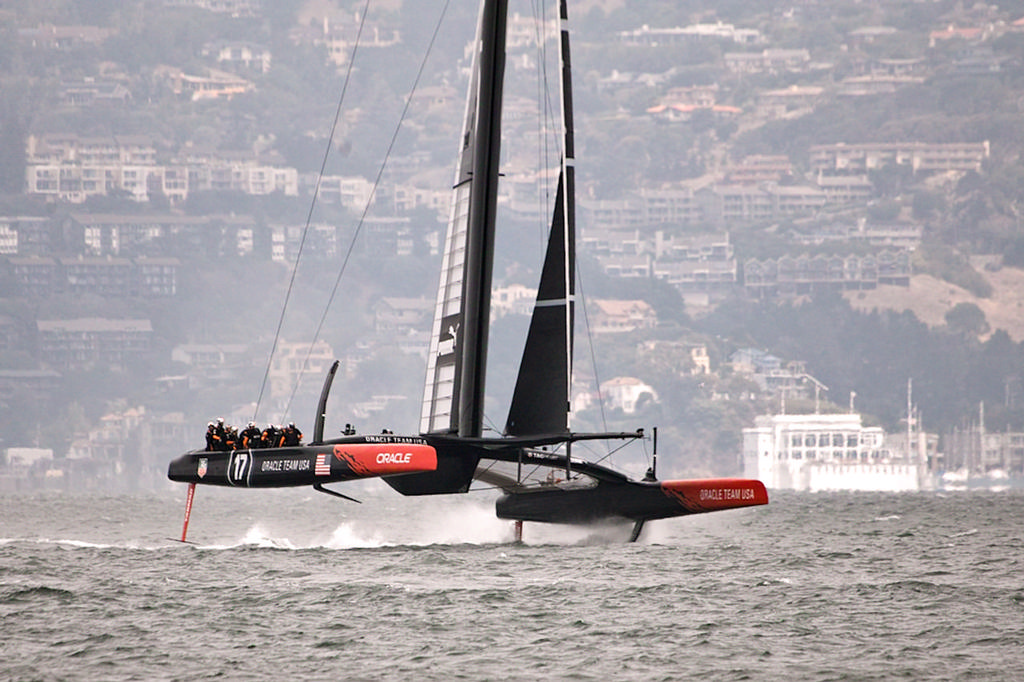 Oracle up on their foils, with the San Francisco YC in the background. (The SFYC is in Marin. Go figure) - America's Cup photo copyright Chuck Lantz http://www.ChuckLantz.com taken at  and featuring the  class