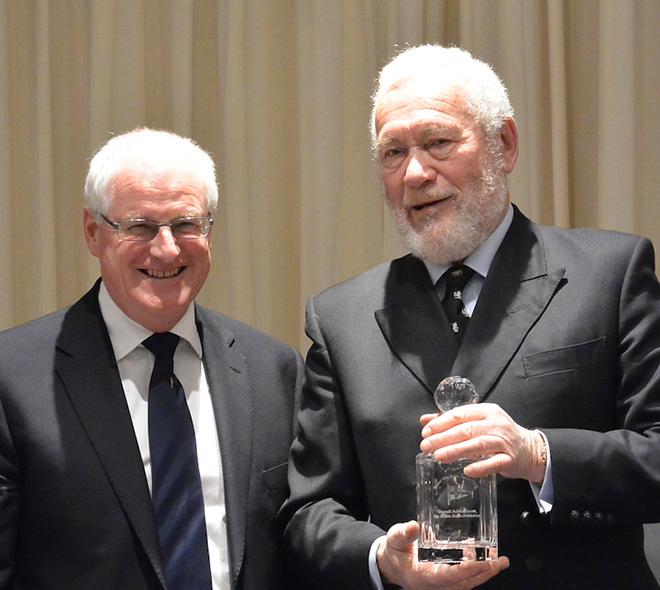 Commodore Chris Mansfield presented Sir Robin with an Achievement Award.  © Sheelagh Cohen