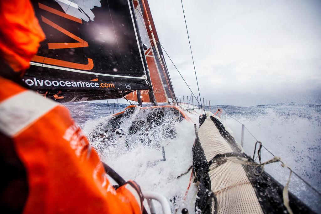 March 24, 2015. Leg 5 to Itajai onboard Team Alvimedica. Day 6. A late night gybe set off a wild day of true Southern Ocean sailing as the temps dropped and the wind and waves built with an approaching low pressure system and accompanying cold front. Stu Bannatyne helping in wet and windy downwind conditions with two reefs in the mainsail. ©  Amory Ross / Team Alvimedica