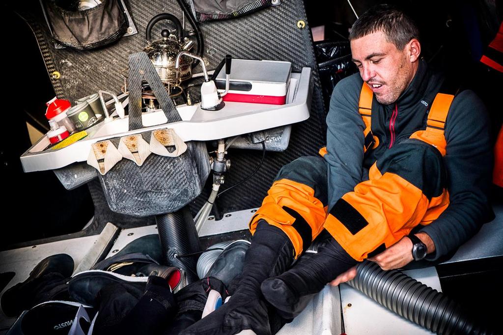 Team Alvimedica - Alberto Bolzan smiles at the comfort of new socks that had been heated by the engine compartment vents. ©  Amory Ross / Team Alvimedica